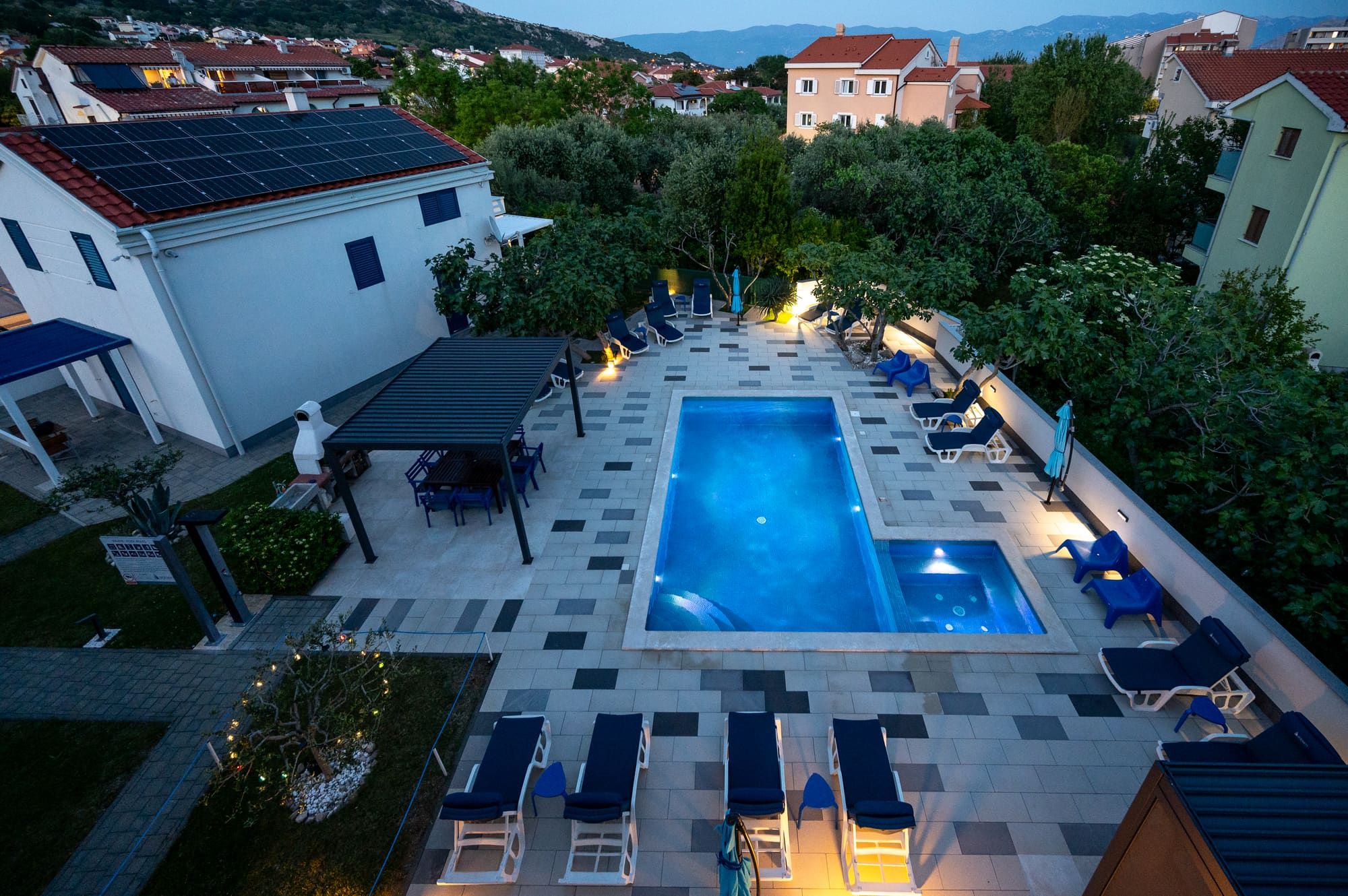 Adorami Apartments — pool and garden at dusk, Baška, island of Krk